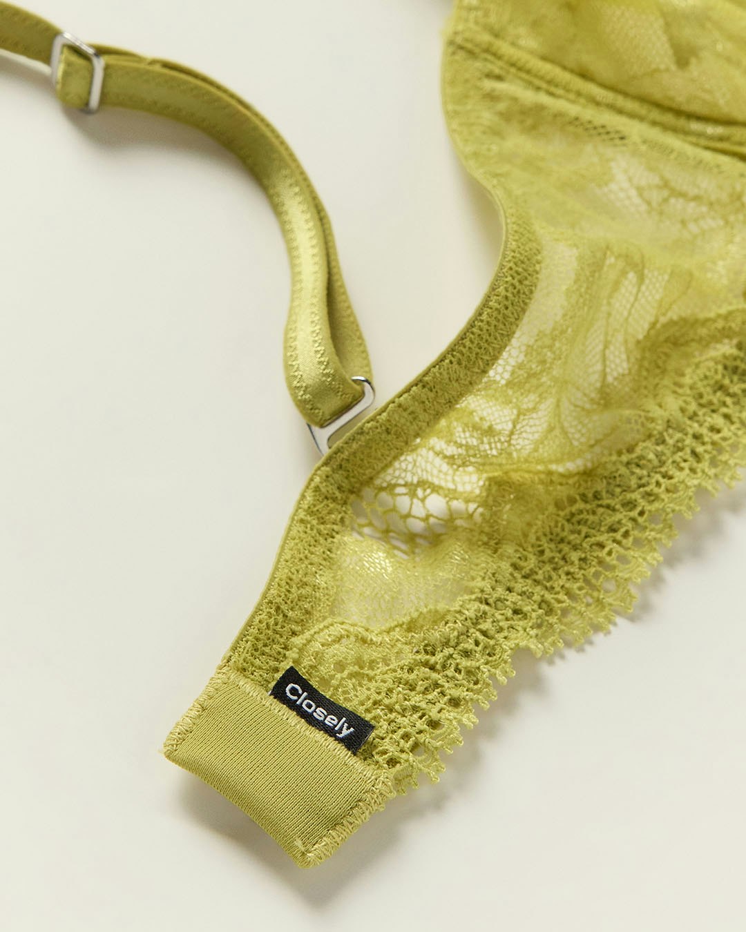 A close-up of a green lace bra