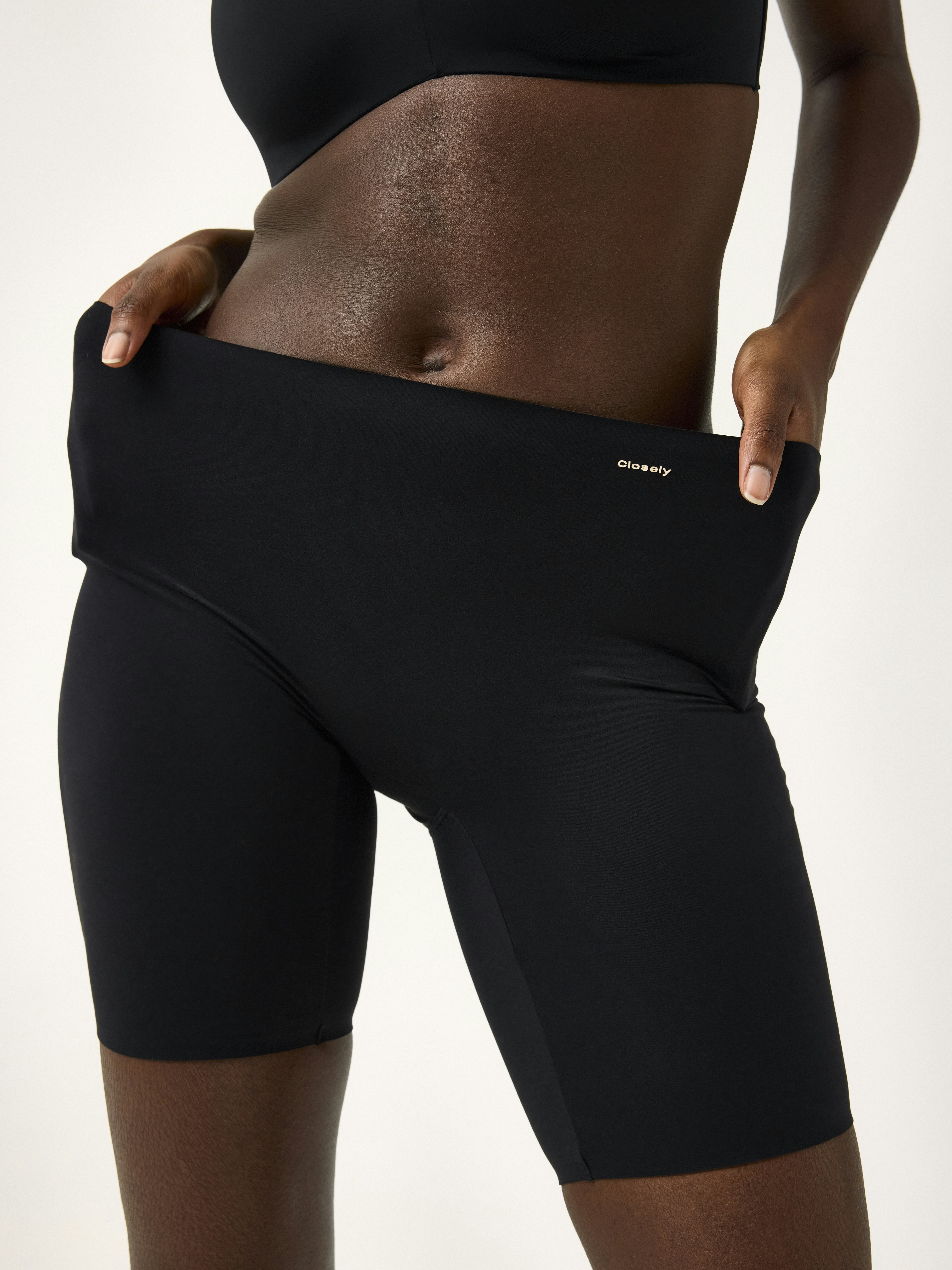 A close-up of a woman wearing black bikers
