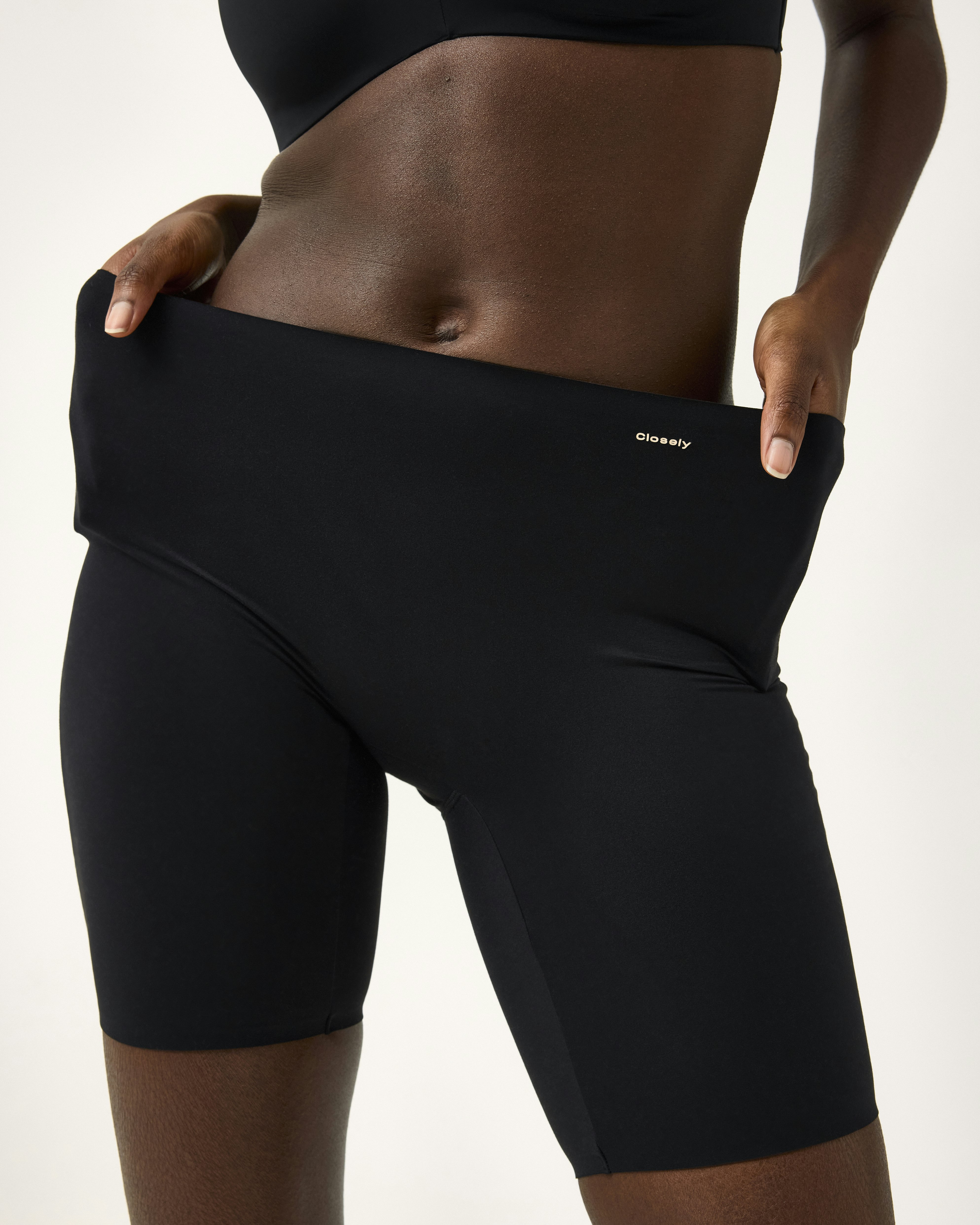 A close-up of a woman wearing black bikers